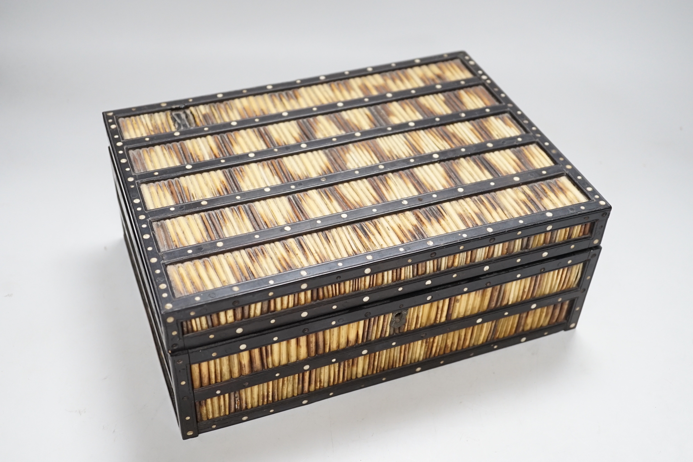 A 19th Century Ceylonese ebony, porcupine quill and bone inlaid sewing box with contents including cotton reels, 28cm wide